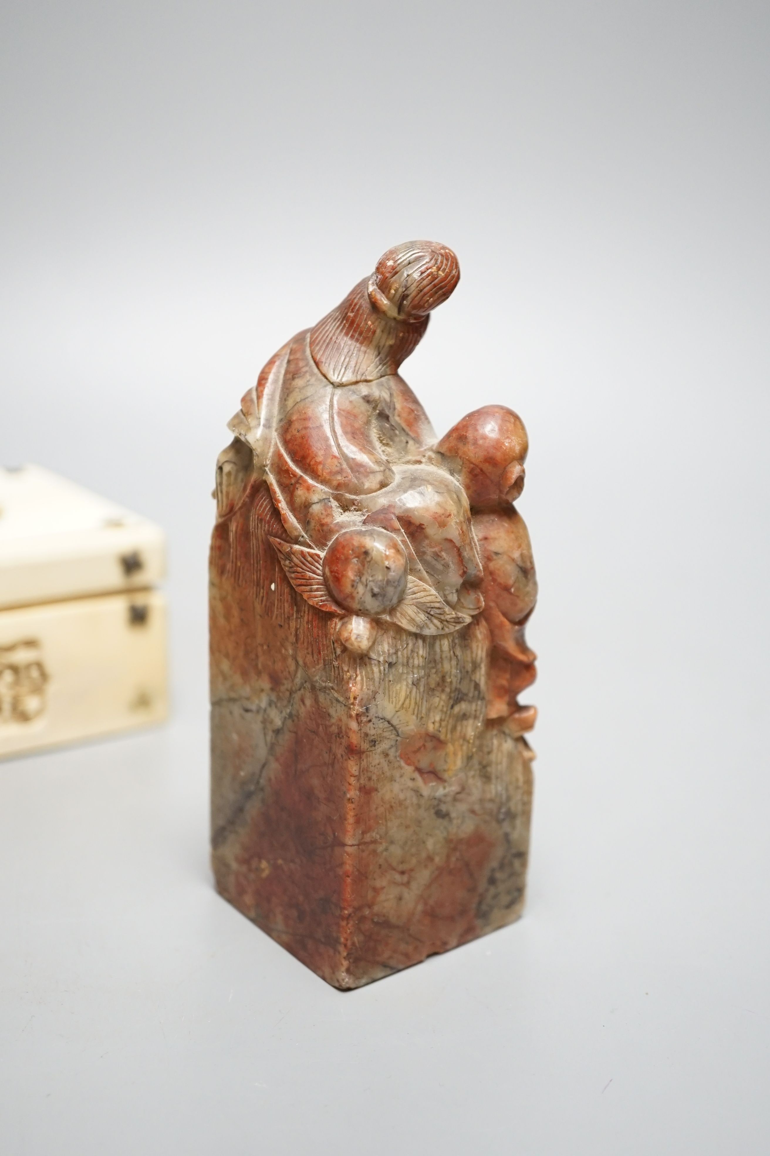 A decorative Chinese carved domino case and a soapstone figural seal (2)